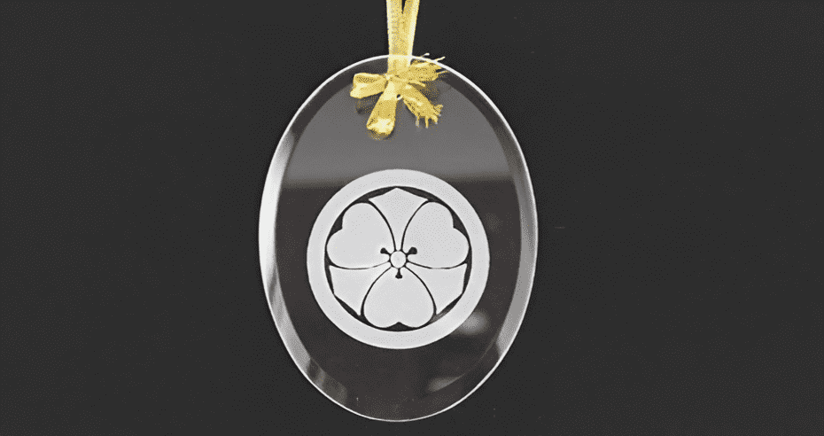 A glass ornament with a flower on it.