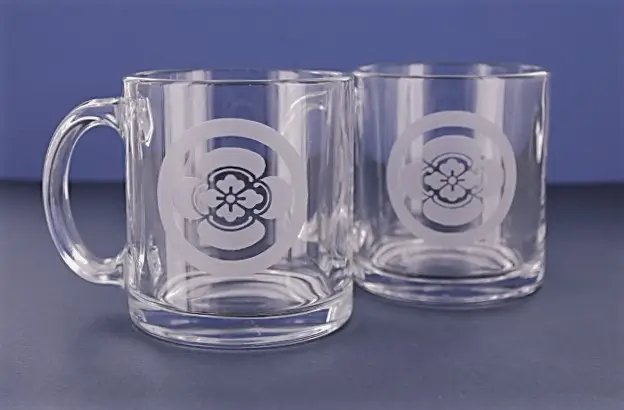 A couple of glasses with the letter c on them.