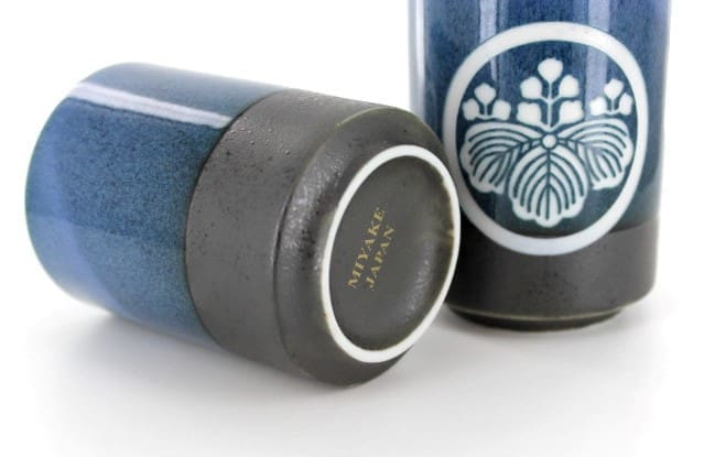 A close up of two blue bottles with black lids