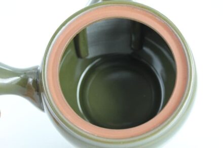 A close up of the bottom of a green cup