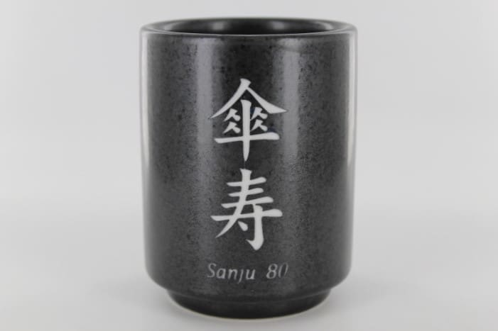 A cup with the name of sanju bi written in chinese.