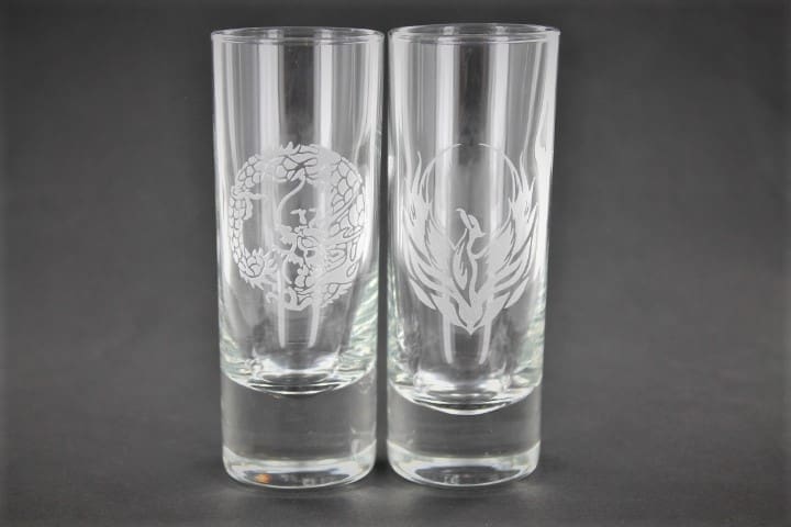 Two shot glasses with a design on them.