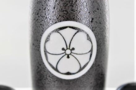 A close up of the black and white flower design on a bottle.