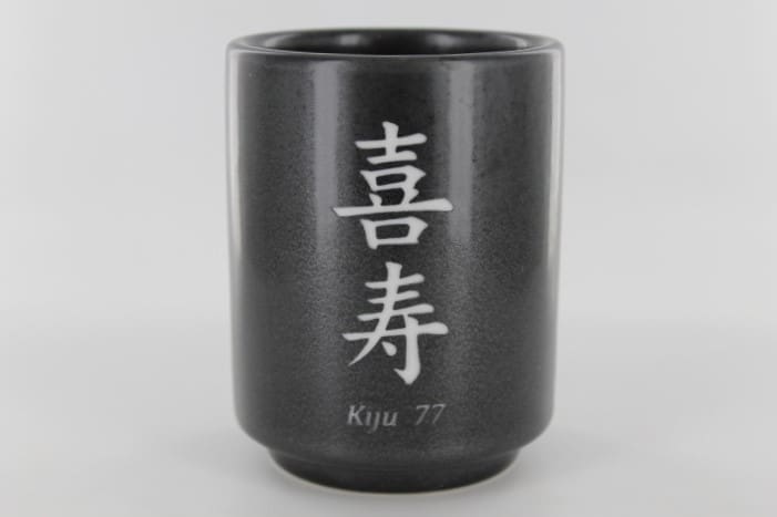 A black cup with the word kija written in chinese.