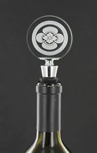 A black and silver knob with a flower design.