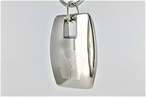 A silver key chain with a large, rectangular pendant.