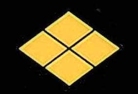 A yellow diamond shaped tile sitting on top of a black background.