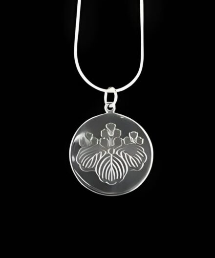 Silver necklace with engraved iris pendant.
